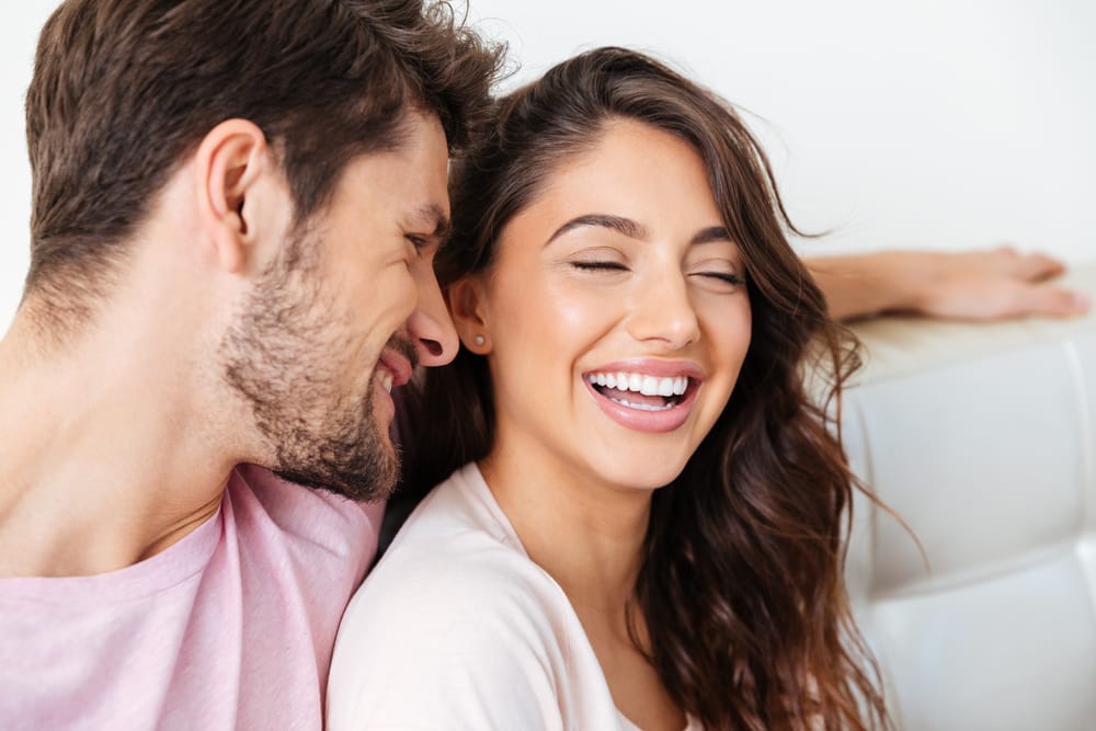 Couple Laughing and Smiling Together – Restorative Dentistry Long Beach A happy couple sharing a laugh, showing bright and healthy smiles that reflect confidence and excellent restorative dental care – Restorative Dentistry Long Beach.